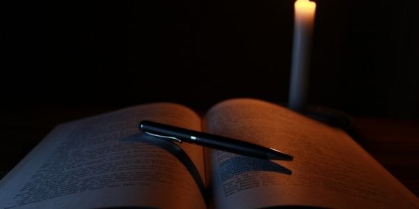 Open book with a pen emphasizing the importance of UPSC Mains Syllabus PDF. Understanding the Syllabus is the first step.